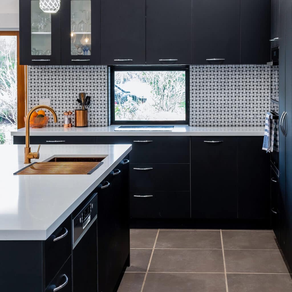 Modern style kitchen renovation with feature splashback and black cabinetry